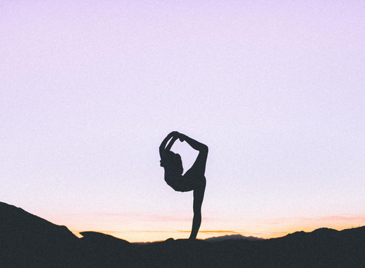 A person as a silhouette doing yoga.
